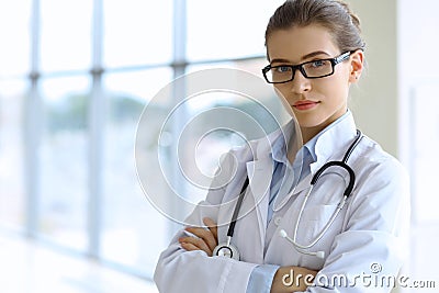Medical doctor woman over clinic interiers background Stock Photo