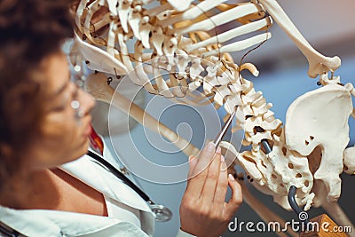 Medical doctor woman teaching anatomy using human skeleton Stock Photo