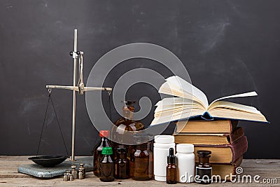 Medical education concept - books, pharmacy bottles, stethoscope in the auditorium with blackboard Stock Photo