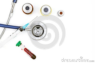 Medical equipment on doctor`s desk, stethoscope ampules and syringe on white background with copy space, close-up Stock Photo