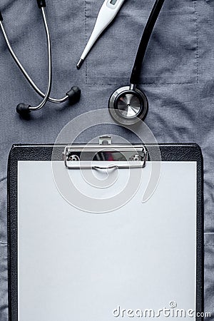 Medical equipment with stethoscope and notebook in doctor`s office on overall background top view mock-up Stock Photo