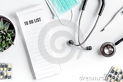 Medical equipment with stethoscope and to do list in doctor`s office on white desk background top view mock-up Stock Photo