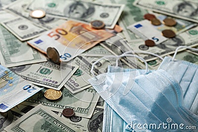 Medical face mask and money, world coronavirus epidemic and economic losses concept Stock Photo