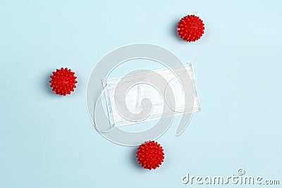 Medical face mask surrounded by abstract coronavirus molecules on blue background Stock Photo