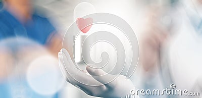 Medical hand with glove heart inside capsule pill Stock Photo