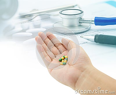 Medical, hand holding capsule pills, stethoscope, pills Stock Photo