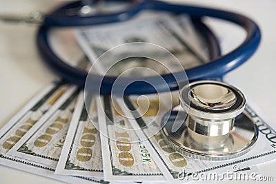 Medical headphones placed dollar money, on the desk. Stock Photo