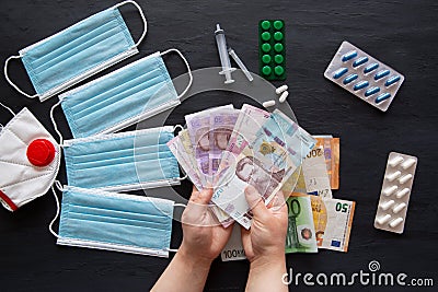 Medical and health costs during coronavirus crisis. Epidemic covid-19 concept in Ukraine. Hryvnia banknotes and pills Stock Photo