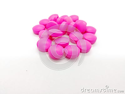 Medical and healthcare concept. Many round pink tablets of Erythromycin 250 mg. isolated on white background, used to treat or pr Stock Photo