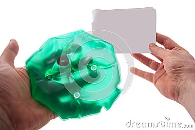 Medical hot-water bottle and empty sheet of paper in hands Stock Photo