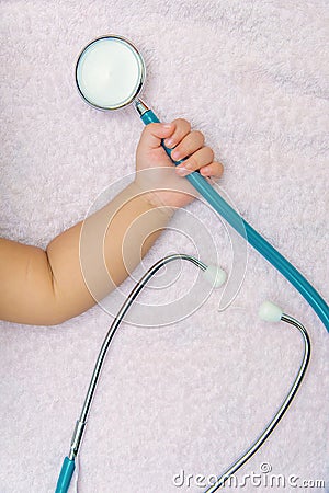 medical instruments stethoscope in hand of baby girl Stock Photo