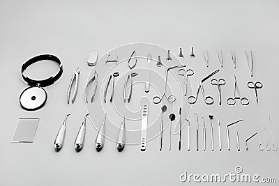 Medical instruments used for surgical operations, laid out on a gray background Stock Photo