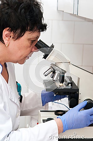 Medical laboratory worker with microscope Stock Photo