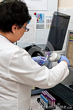 Medical laboratory worker taking infra red readout Stock Photo