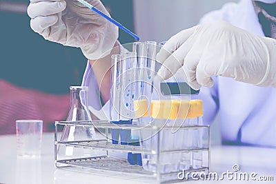 Medical or male medical in laboratory room research performs tests with blue liquid, Stock Photo