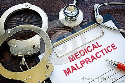 Medical malpractice form with stethoscope and handcuffs. Stock Photo