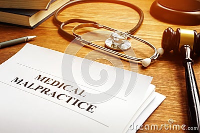 Medical malpractice report and stethoscope. Stock Photo