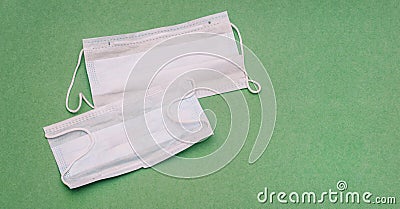 Medical mask on a green background. Respiratory protection. Mask covering the mouth and nose Stock Photo