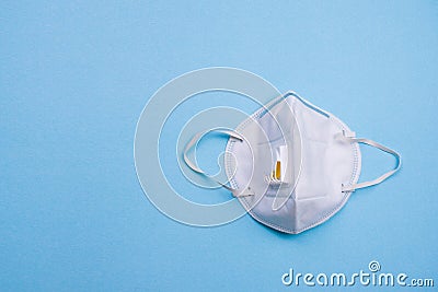 Medical mask on blue background. N95 or white surgical mask for coronavirus outbreak, Covid-19, virus, flu and pollution Stock Photo