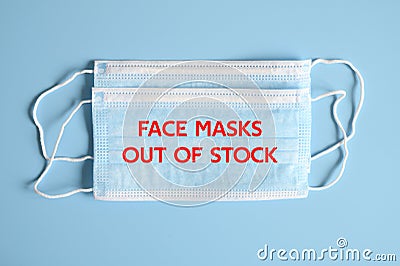 Medical masks blue color with text `face masks out of stock` on a blue background. OFL font Stock Photo