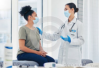 Medical nurse consulting a patient for covid before vaccine while wearing a face mask during pandemic. Healthcare worker Stock Photo