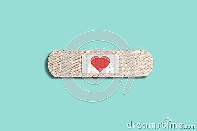 Medical patch with red heart on blue background. Abstract love concept, healing patch, broken love Stock Photo