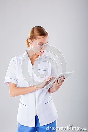 Medical person: doctor portrait. Confident young woman medical professional on white background. Stock Photo