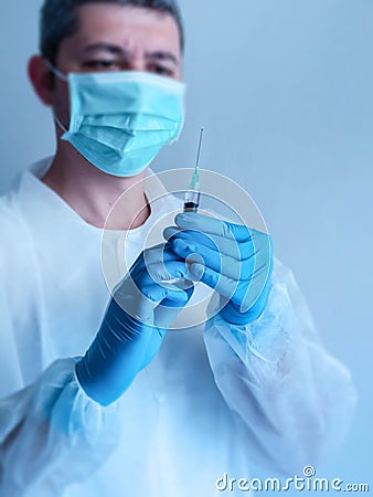 Medical person holding syringe close up Stock Photo