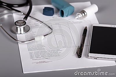 Medical phonendoscope, an inhaler and sheet of doctor appointments Stock Photo