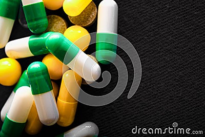 Medical pills. Color capsules medication. Black background. Health care concept. Free space for text. Medicines. Many different Stock Photo