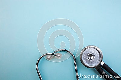 Medical pressure gauge and stethoscope on light blue background, for heart listening, isolated place for text Stock Photo