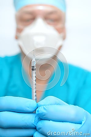 A medical professional is holding a syringe Stock Photo