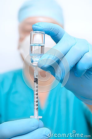 A medical professional is holding a syringe Stock Photo