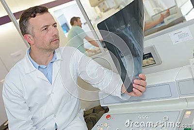 Medical professional inspecting x-ray result Stock Photo