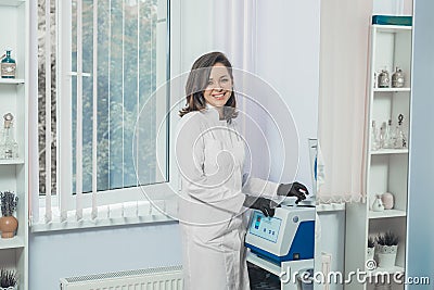 Medical professional puts a tube in machine. doctor smiles. Medical hospital Stock Photo