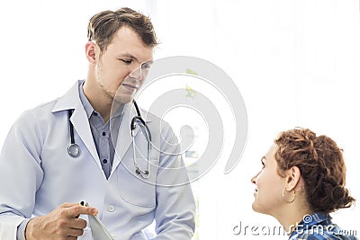 Medical professionals Caucasian man reassuring and talking with young woman stress patient. Stock Photo