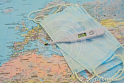 Medical protective mask on world map. Covid-19.face mask, thermometer. Virus in Italy Editorial Stock Photo
