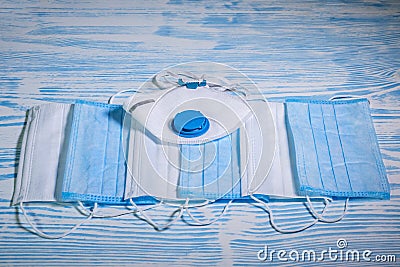 Medical protective masks on a blue wooden surface. Cavid-19 coronavirus infections Stock Photo