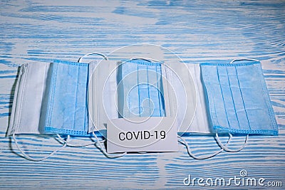 Medical protective masks on a blue wooden surface. Cavid-19 coronavirus infections Stock Photo