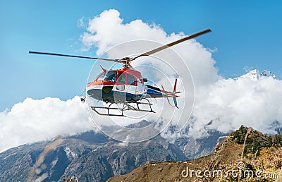 Medical Rescue helicopter landing in high altitude Himalayas mountains. Safety and travel insurance concept image Stock Photo