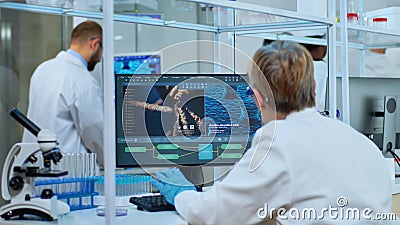 Medical research scientist typing codes on computer Stock Photo