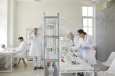 Medical research scientists working at laboratory using advanced equipment Stock Photo