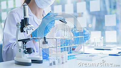 Medical or scientific researcher or man doctor looking at a test tube of clear solution in a laboratory Stock Photo