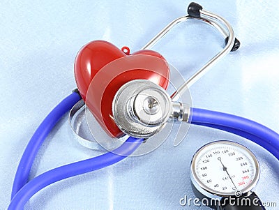 Medical stethoscope head and red toy heart lying on cardiogram chart closeup. help, prophylaxis, disease prevention or insurance Stock Photo