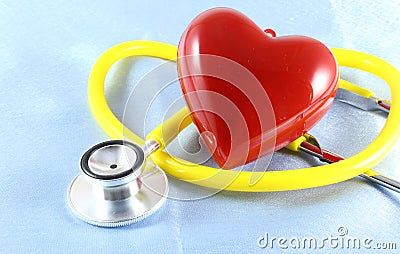 Medical stethoscope head and red toy heart lying on cardiogram chart closeup. help, prophylaxis, disease prevention or insurance Stock Photo