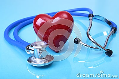 Medical stethoscope and red heart on blue mirror background. you can place your text. Stock Photo