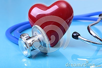 Medical stethoscope and red heart on blue mirror background. you can place your text. Stock Photo