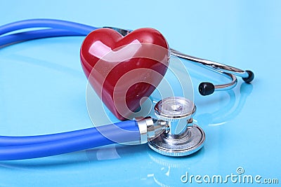 Medical stethoscope and red heart on blue mirror background. you can place your text. Stock Photo