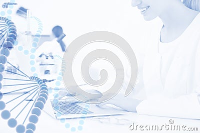 Medical student working with laptop in modern scientific laboratory and graphic DNA strand, l Stock Photo