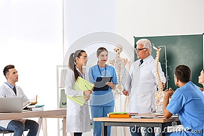 Medical students and professor studying human spine structure Stock Photo